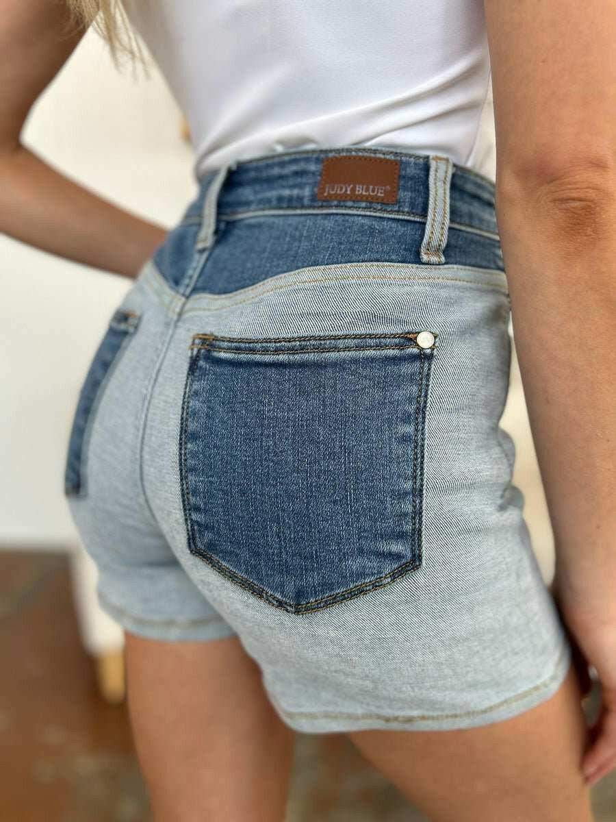 Judy Blue Color Block Denim ShortsStep into summer with an exclusive touch of modern flair featuring the Judy Blue Color Block Denim Shorts. Designed for trendsetters who demand both style and comforJean ShortsJudy Blue Color Block Denim Shorts