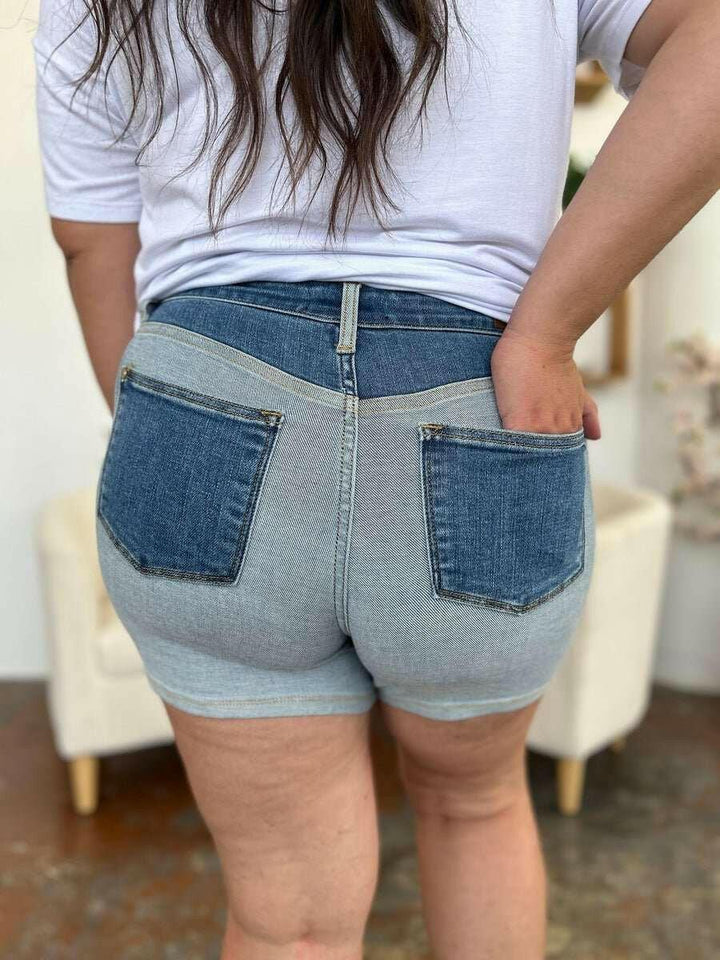 Judy Blue Color Block Denim ShortsStep into summer with an exclusive touch of modern flair featuring the Judy Blue Color Block Denim Shorts. Designed for trendsetters who demand both style and comforJean ShortsJudy Blue Color Block Denim Shorts