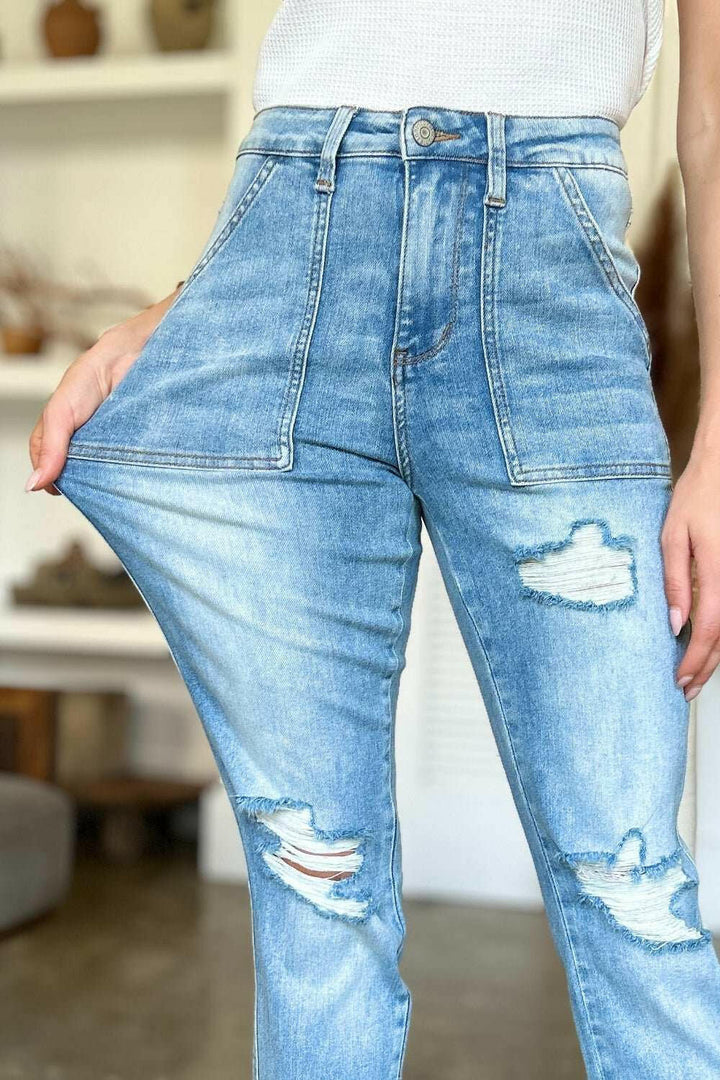 Judy Blue Distressed Straight Leg Jeans with Patch PocketsThese distressed straight jeans feature stylish patch pockets for added flair. The distressed detailing adds a trendy touch to your look. The straight cut offers a fStraight Leg JeansJudy Blue Distressed