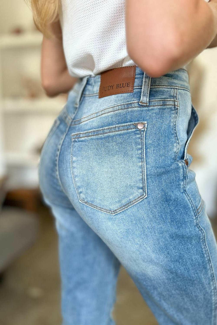 Judy Blue Distressed Straight Leg Jeans with Patch PocketsThese distressed straight jeans feature stylish patch pockets for added flair. The distressed detailing adds a trendy touch to your look. The straight cut offers a fStraight Leg JeansJudy Blue Distressed