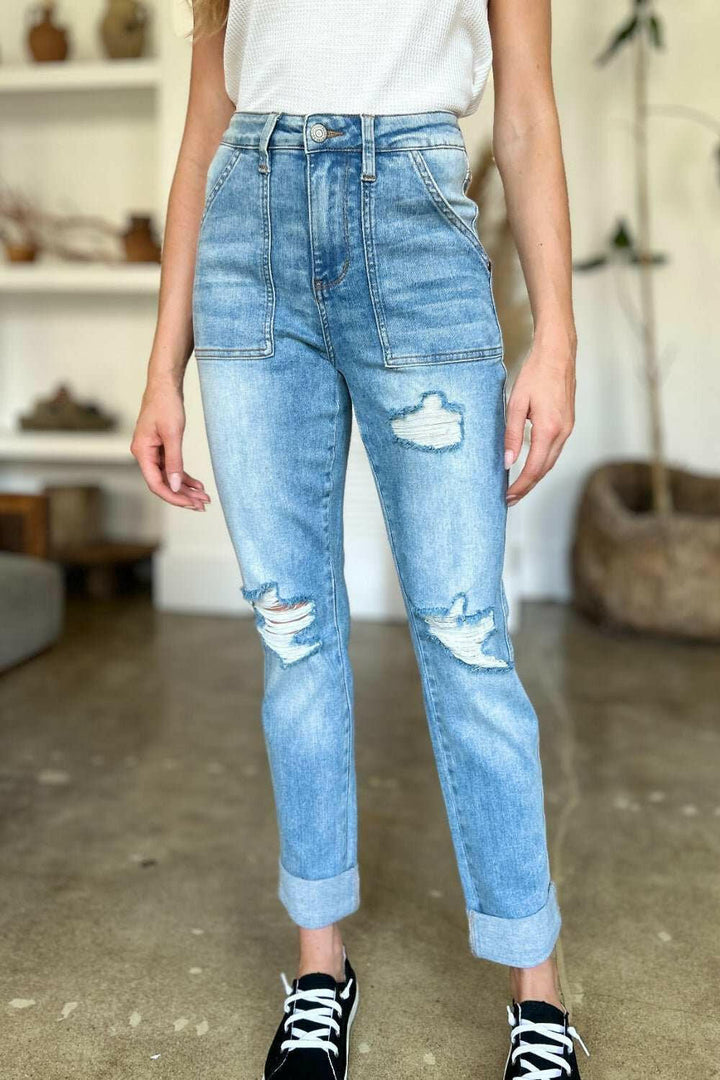 Judy Blue Distressed Straight Leg Jeans with Patch PocketsThese distressed straight jeans feature stylish patch pockets for added flair. The distressed detailing adds a trendy touch to your look. The straight cut offers a fStraight Leg JeansJudy Blue Distressed