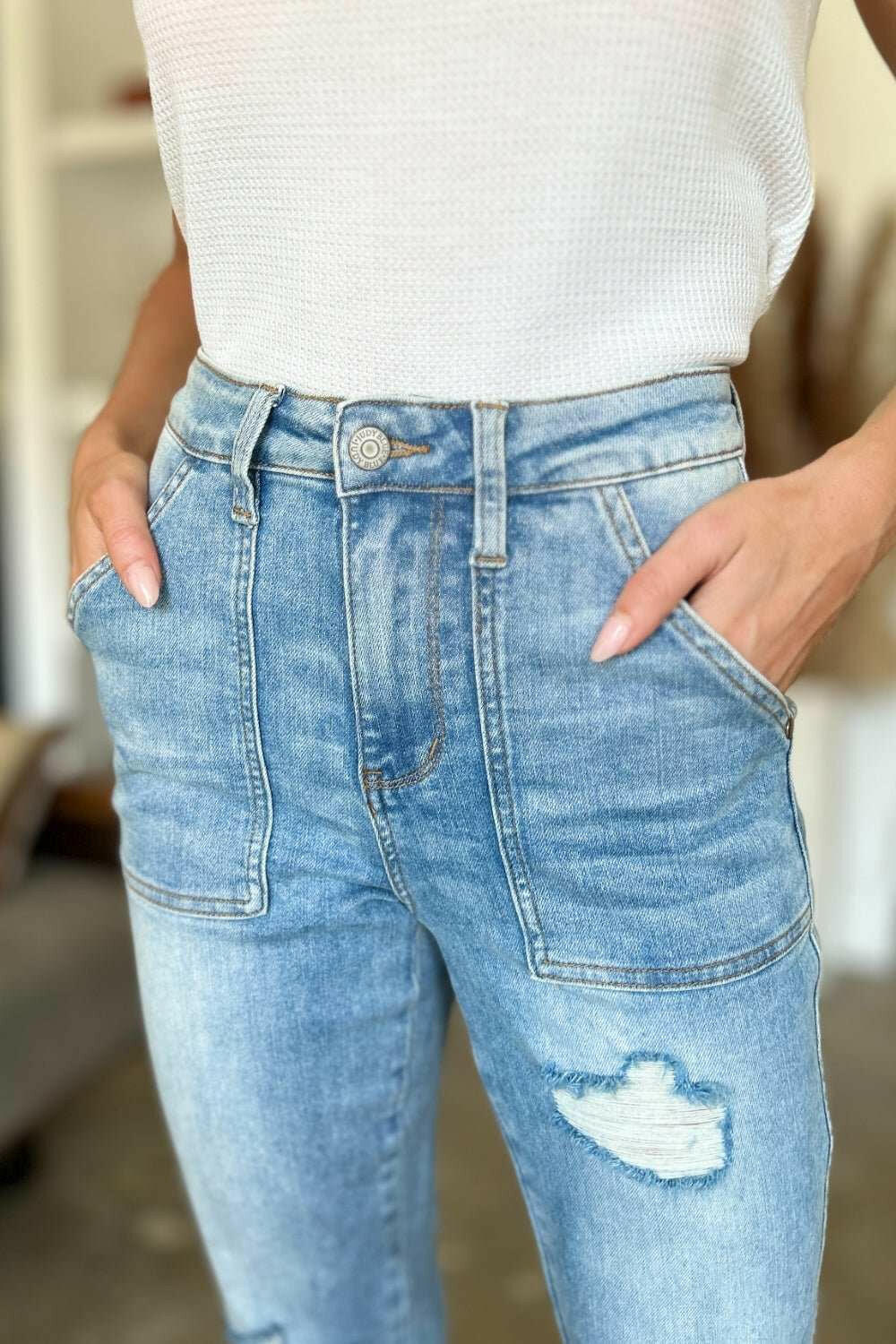 Judy Blue Distressed Straight Leg Jeans with Patch PocketsThese distressed straight jeans feature stylish patch pockets for added flair. The distressed detailing adds a trendy touch to your look. The straight cut offers a fStraight Leg JeansJudy Blue Distressed
