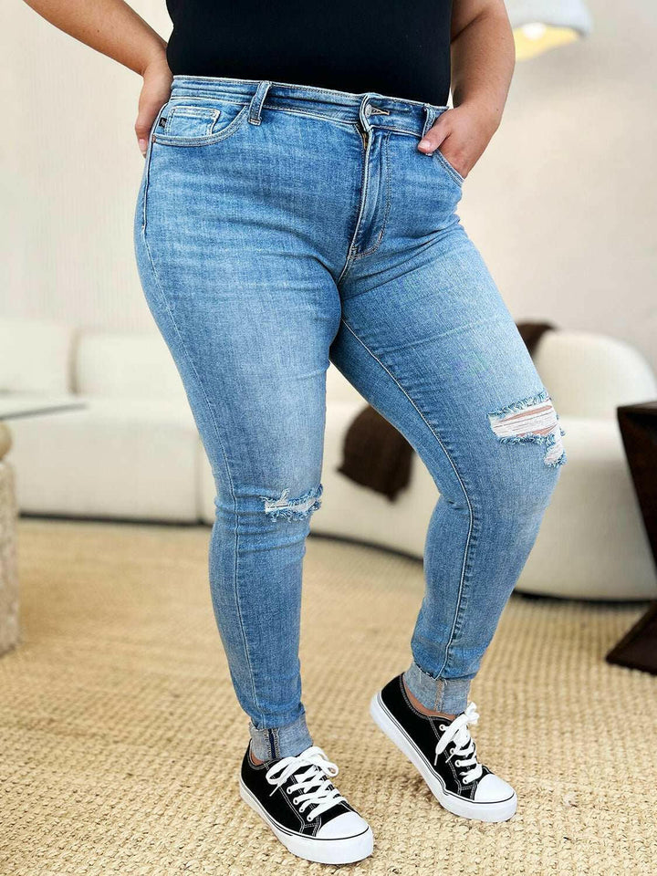 Judy Blue Mid Rise Destroy & Cuff Skinny JeansThese Judy Blue jeans are effortlessly cool, featuring a mid rise waist for a flattering silhouette and destroyed detailing for a rebellious touch. The cuffed hem adSkinny JeansJudy Blue Mid Rise