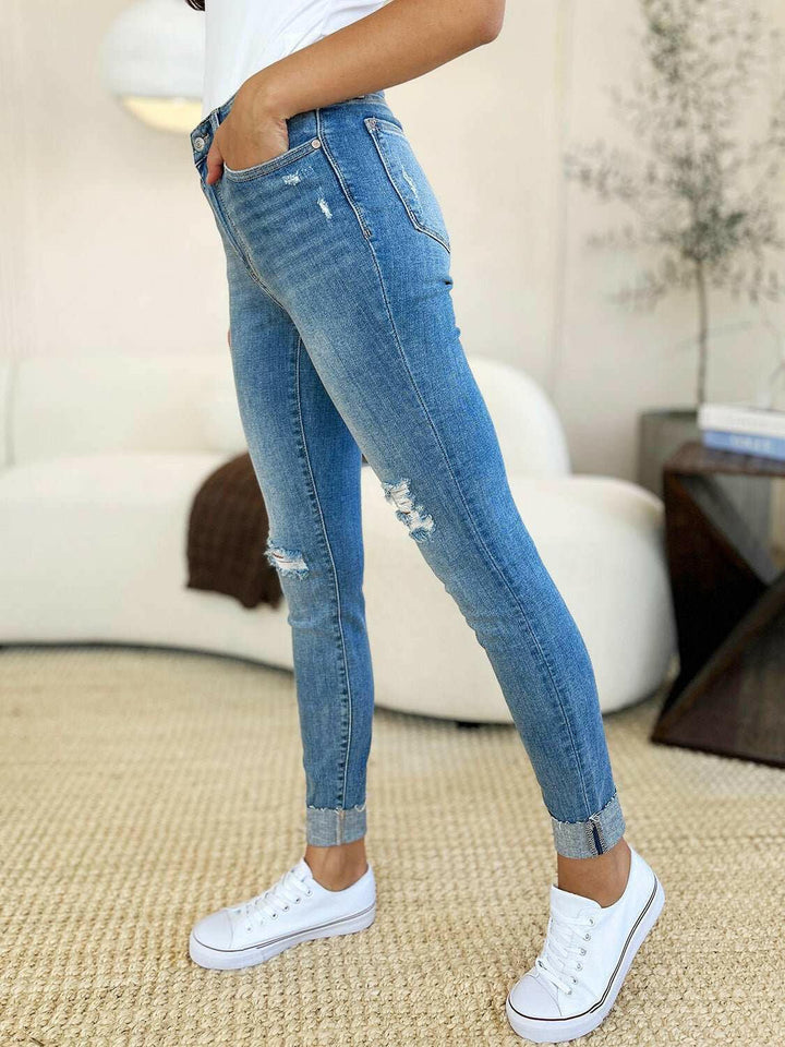 Judy Blue Mid Rise Destroy & Cuff Skinny JeansThese Judy Blue jeans are effortlessly cool, featuring a mid rise waist for a flattering silhouette and destroyed detailing for a rebellious touch. The cuffed hem adSkinny JeansJudy Blue Mid Rise