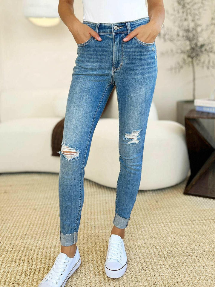 Judy Blue Mid Rise Destroy & Cuff Skinny JeansThese Judy Blue jeans are effortlessly cool, featuring a mid rise waist for a flattering silhouette and destroyed detailing for a rebellious touch. The cuffed hem adSkinny JeansJudy Blue Mid Rise