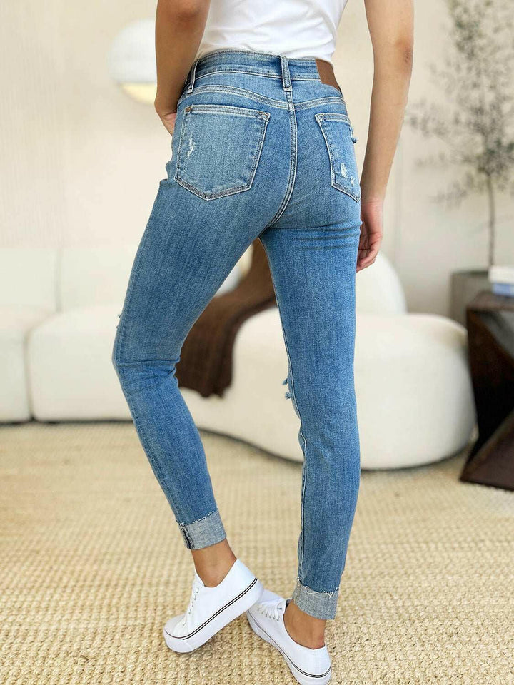 Judy Blue Mid Rise Destroy & Cuff Skinny JeansThese Judy Blue jeans are effortlessly cool, featuring a mid rise waist for a flattering silhouette and destroyed detailing for a rebellious touch. The cuffed hem adSkinny JeansJudy Blue Mid Rise