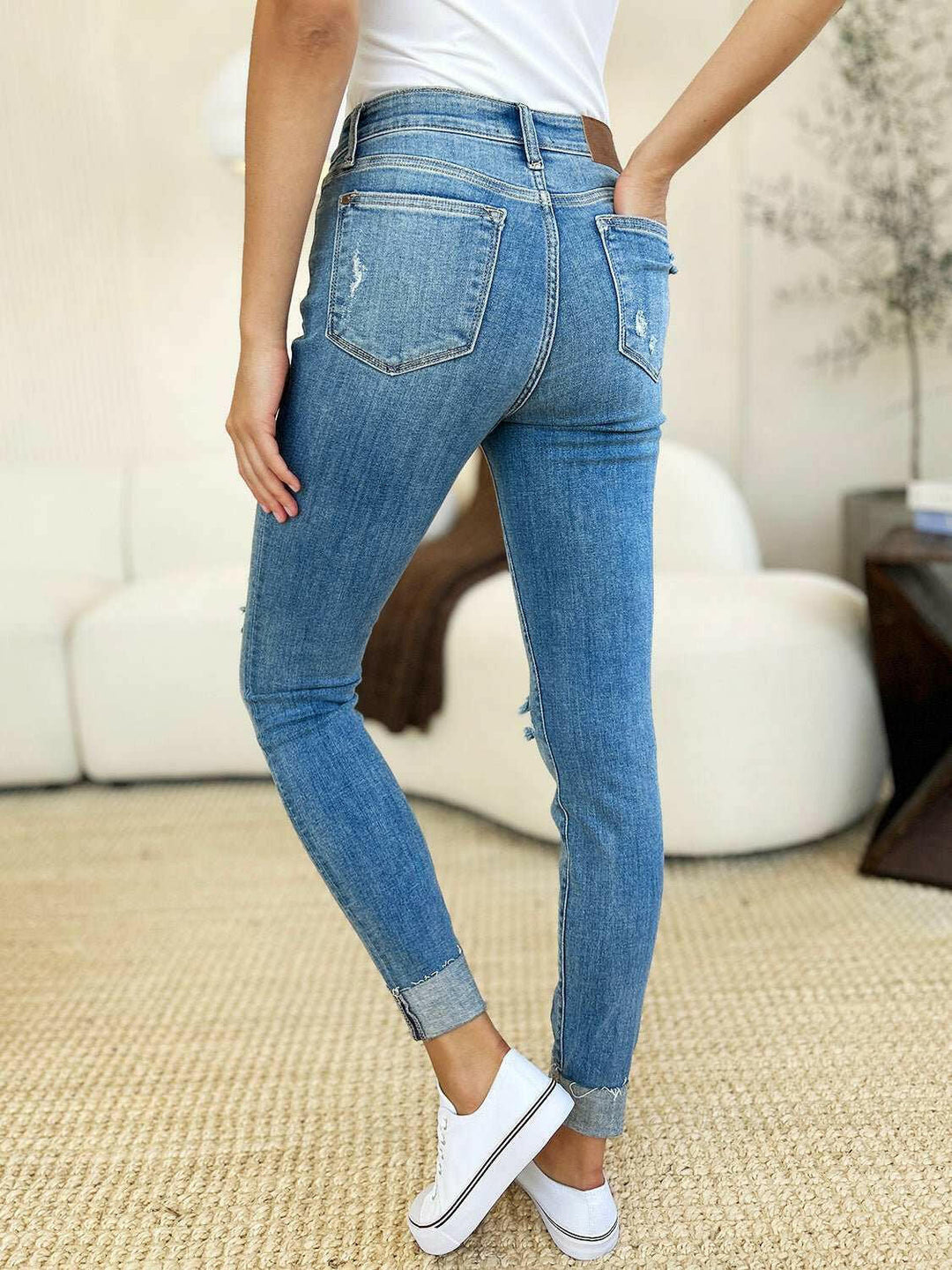 Judy Blue Mid Rise Destroy & Cuff Skinny JeansThese Judy Blue jeans are effortlessly cool, featuring a mid rise waist for a flattering silhouette and destroyed detailing for a rebellious touch. The cuffed hem adSkinny JeansJudy Blue Mid Rise