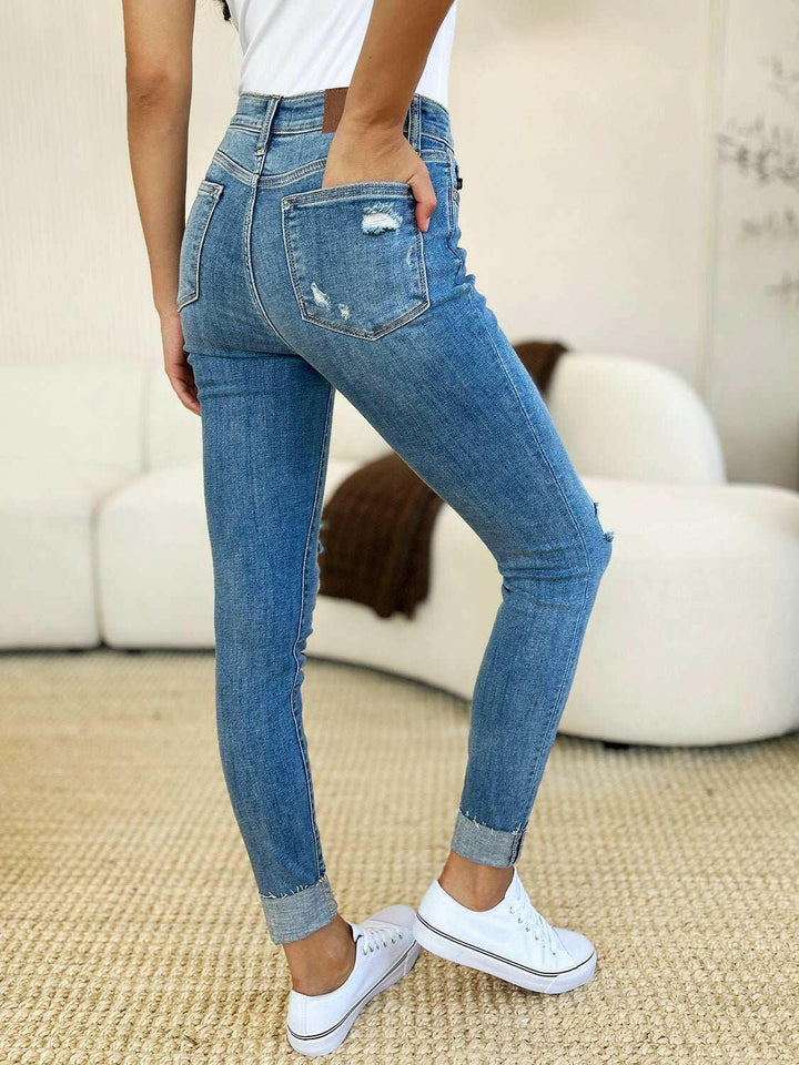 Judy Blue Mid Rise Destroy & Cuff Skinny JeansThese Judy Blue jeans are effortlessly cool, featuring a mid rise waist for a flattering silhouette and destroyed detailing for a rebellious touch. The cuffed hem adSkinny JeansJudy Blue Mid Rise